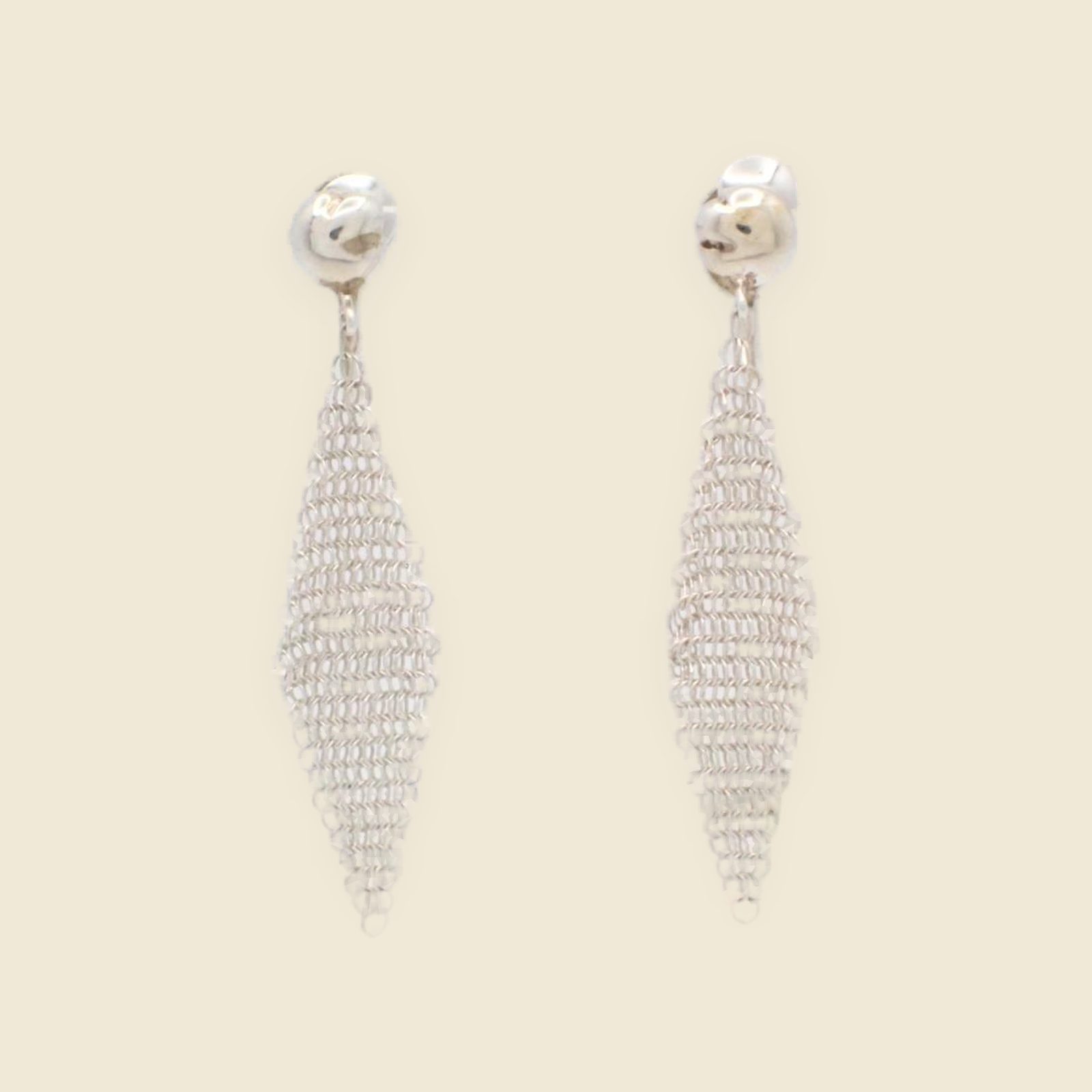 Orecchini a clip Tiffany in argento sterling con pendente a maglia metallica a losanga, su fondo chiaro