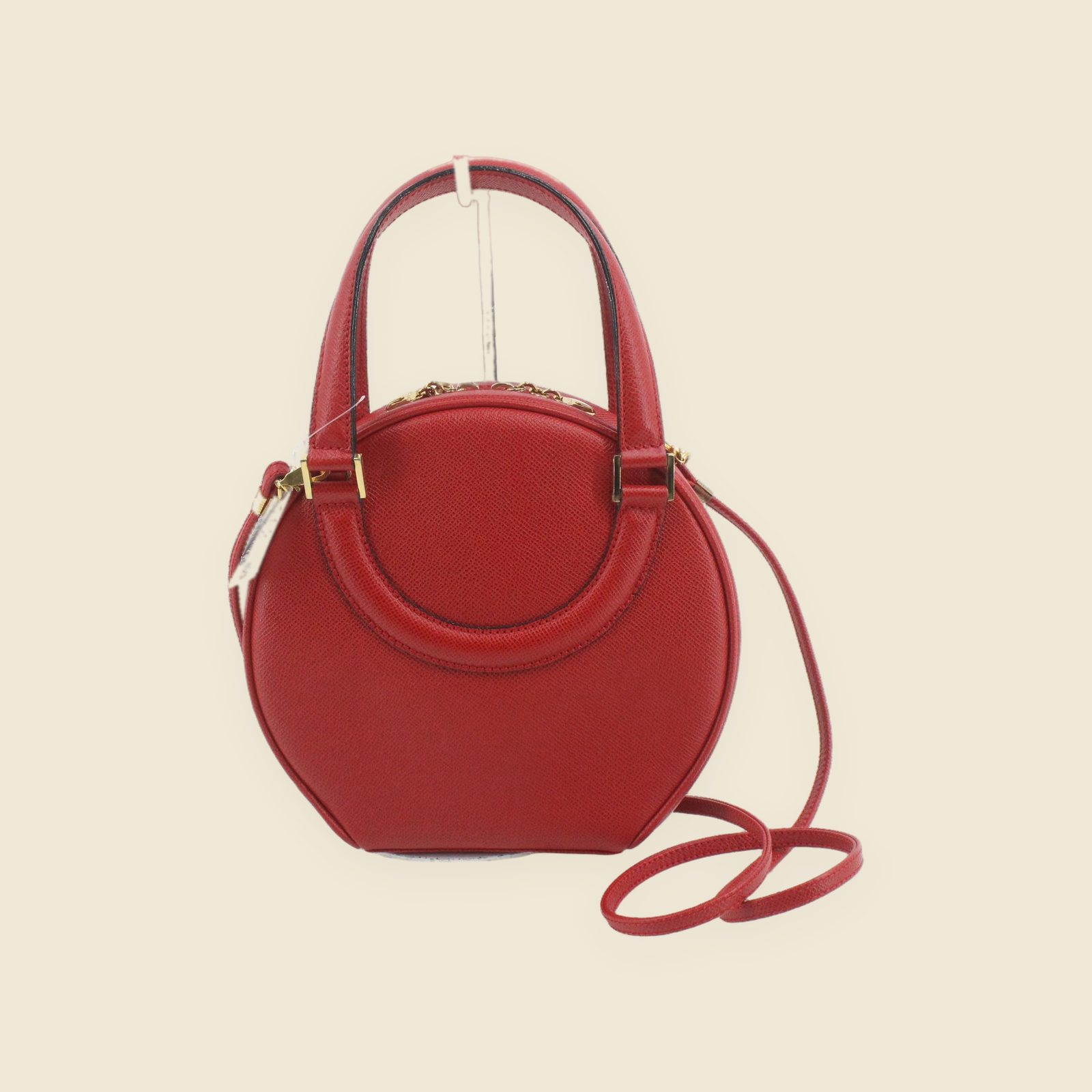 Borsa a mano tonda Bally in pelle granulata rossa, vista frontale, con doppi manici, tracolla e ferramenta dorata