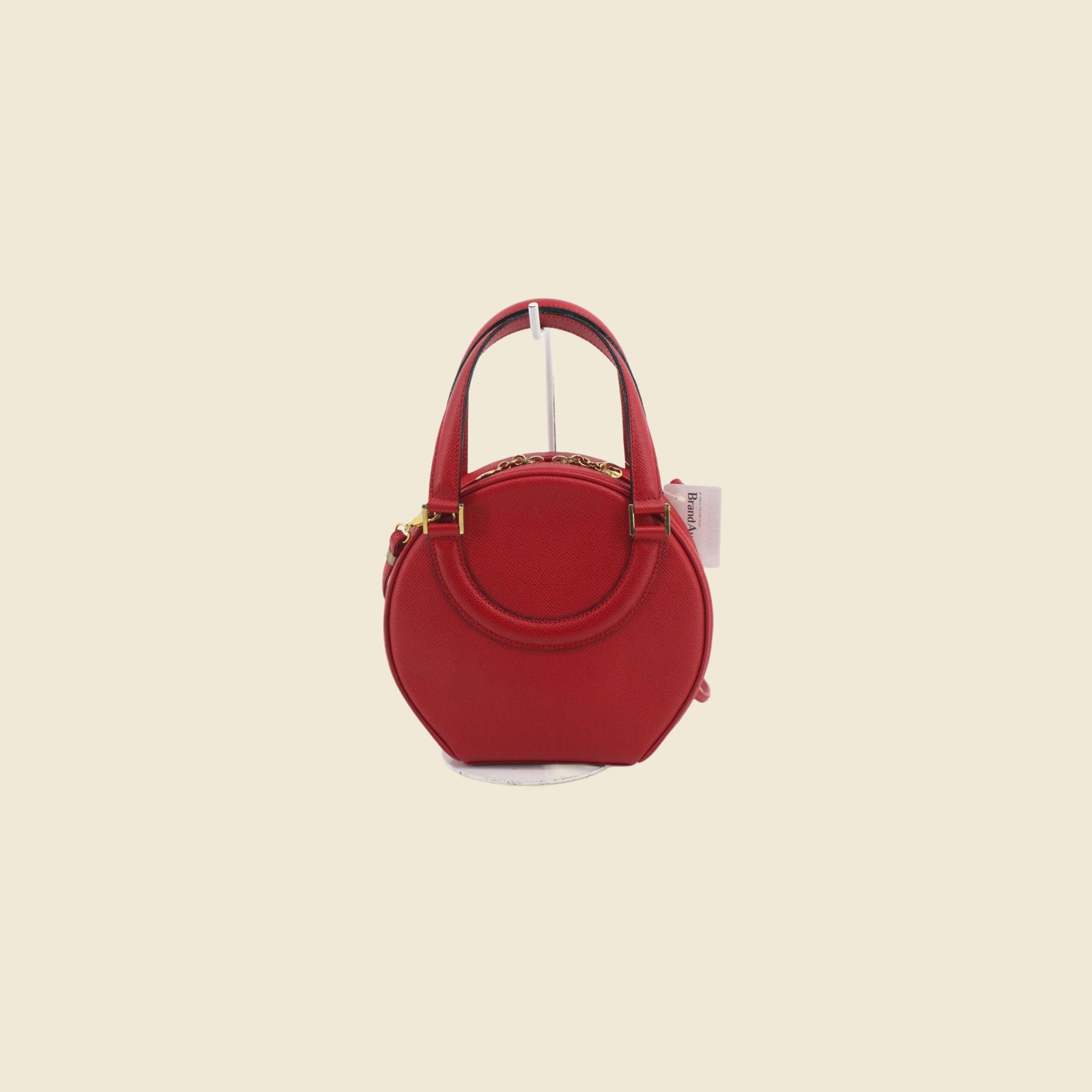 Borsa a mano Bally tonda in pelle granulata rossa con ferramenta dorata, doppio manico e tracolla, vista frontale — vista 2