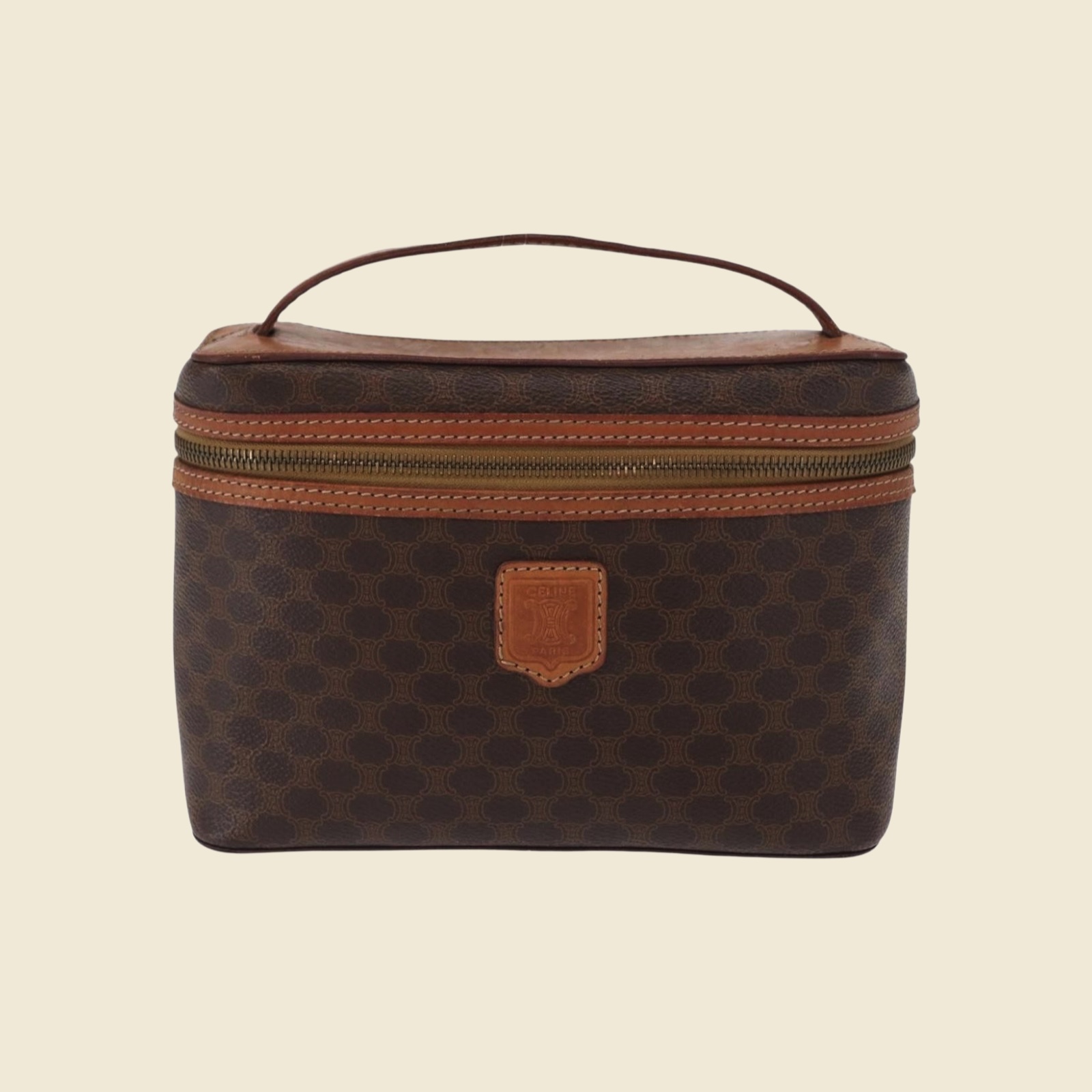 Borsa vanity Celine in tela monogramma marrone e pelle, manico superiore e zip dorata, vista frontale su fondo bianco