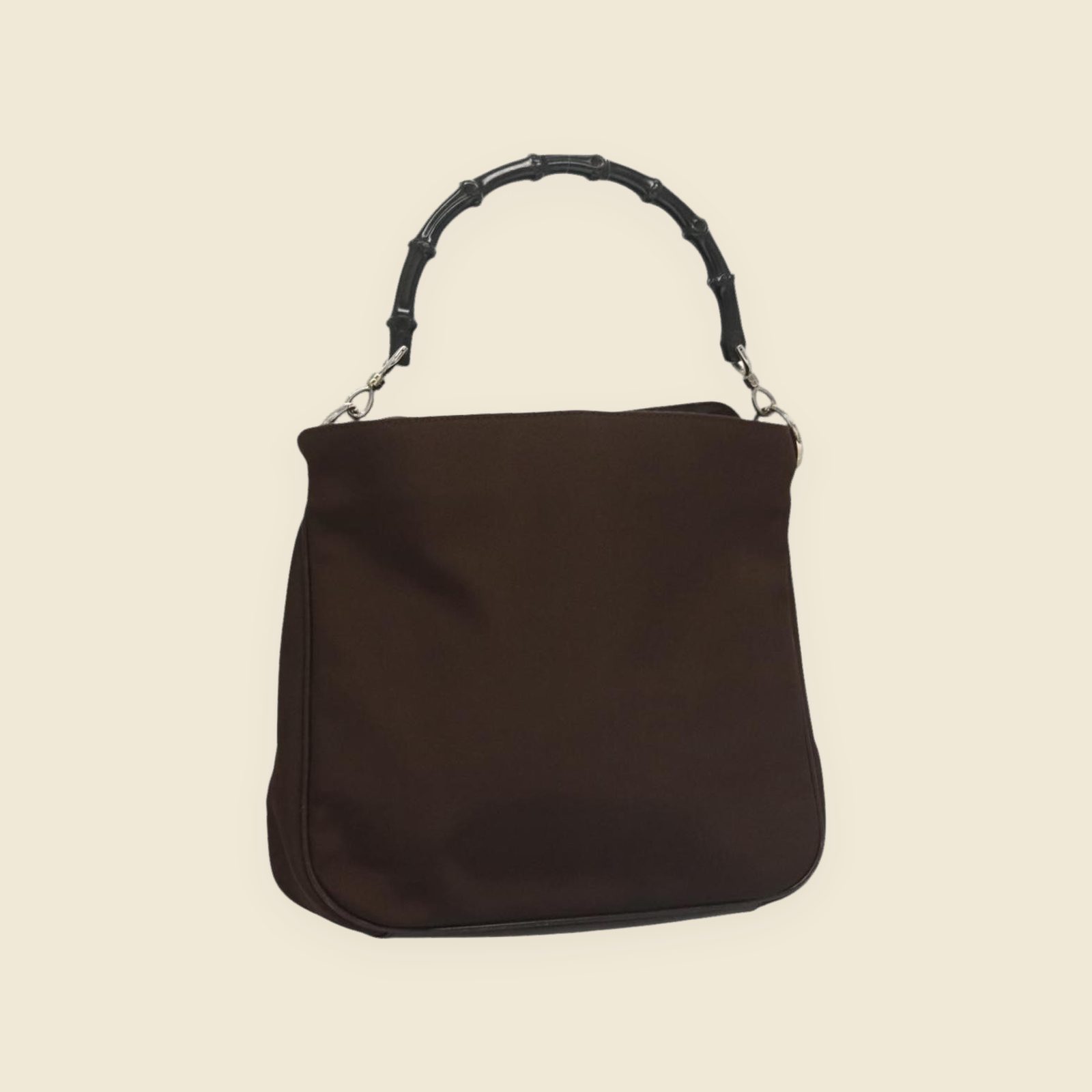Borsa a mano Gucci in nylon marrone con manico in bambù nero e ferramenta argentata, vista frontale su fondo neutro